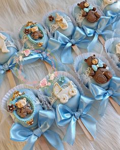 several baby shower items are arranged on a furnishing area with blue ribbons and bows