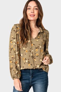 Complete your look with a classic blouse; featuring a smocked yoke, ruffle details, blouson sleeves, and a tie front. 100% Rayon Delicate Wash Cycle, Dry Flat. Length 26" (size small) Jing is 5'8 and wearing size XXS in IvoryNattalie is 5'9 and wearing XXS in Olive Fall Floral