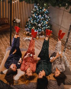 three women laying on the floor with their feet up in the air and wearing red mittens