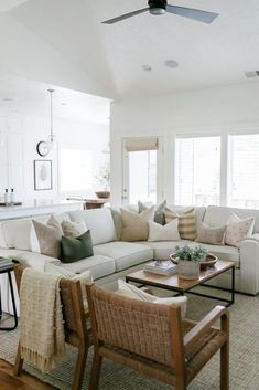 a living room filled with furniture and a ceiling fan