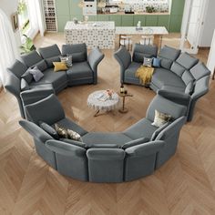 a living room filled with gray couches and chairs on top of wooden flooring