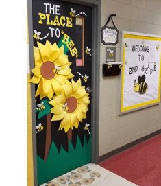 a classroom door decorated with sunflowers and the words the place to be on it