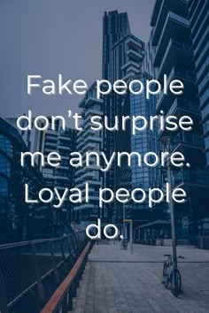 the words fake people don't surprise me anymore, loyal people do in front of tall buildings