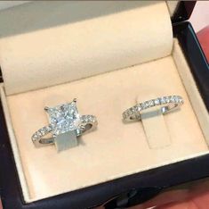 two engagement rings in a box on display