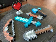 several pieces of art made out of legos on a table in a living room