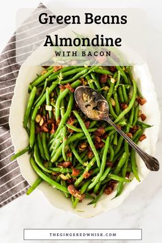 green beans with bacon in a white bowl on top of a striped towel and spoon