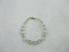 "Green and white beaded bracelet. Light green faceted beads, clear seed beads, and faux pearls. Lobster claw fastener. Length: 8 3/8\" Item # GW0083" Green Beaded Pearl Bracelets, Green Pearl Beaded Bracelets, Adjustable Green Beaded Pearl Bracelet, White Beaded Bracelet, Green Beaded Bracelets, Green Beaded Necklace, Blue Beaded Necklace, Jewellery Sketches, Gold Bead Necklace