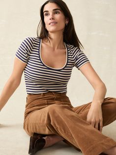 Crafted from our very own premium stretch pima cotton, this tee offers luxurious softness with an effortless fit. The ribbed knit adds subtle texture, transforming a classic wardrobe staple into a stylish piece that works for laid-back outings to more polished occasions all year-round. This is our go-to top for balancing out flowy, maxi skirts and wide-legged pants. Fit: Slim fit Detail: Open scoop neckline. Short sleeve length. Material: 54% Pima Cotton, 36% Modal, 10% Elastane Model: Gabriella is 5'9.5 wearing size Small  Care: Turn inside out. Machine Wash cold with like colors. Gentle cycle. Do not bleach. Tumble dry low. Remove promptly. Cool iron when needed. WKF2431-MTE Tank Jumpsuit, Flowy Maxi Skirts, Swim Pants, Classic Wardrobe Staples, Classic Wardrobe, Linen Shop, Dress Shirts For Women, Sweater Sale, Knit Tees