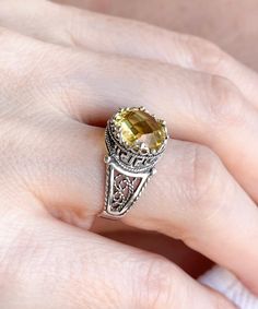 "This everyday use, lace embroidery minimalist sterling 925 sterling silver filigree art crown cocktail ring has citrine gemstone. The ring face is 0.47\" / 12.00 mm. Citrine gemstone is 10 mm, double side faceted, checkerboard round-cut. It takes its name from the citron fruit because of these lemon-inspired shades. Citrine is the traditional birthstone for November, and is an alternate Zodiac stone for Scorpio. This yellow stone, filigree art, dainty ring would make the perfect option for a bi Exquisite Filigree Ring In White Gold, Exquisite White Gold Filigree Ring Gift, Exquisite White Gold Filigree Ring As Gift, Exquisite Citrine Rings As A Gift, Citrine Jewelry With Accent Stones For Gift, Yellow Filigree Jewelry Gift, Sterling Silver Filigree Ring With Gemstone For Gift, Elegant Silver Citrine Jewelry, Elegant Silver Jewelry With Citrine