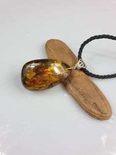 Welcome to my handmade shop. Item description: Dark green unisex Amber pendant with some light yellow parts. Rough Amber. Healthy stone. Long black cord (about 60 cm) Weight: 27.80 gr Lenght:7-3.5 cm (2.75-1.37 inches) This item was made of natural Baltic Amber. All the amber used in my jewelry is collected in my home country Lithuania. I sell only genuine, authentic, real, natural Baltic Amber. Item may have natural imperfections. Due to amber being natural, each of my jewelry is unique and eve Handmade Baltic Amber Pendant Necklace, Handmade Brown Baltic Amber Necklace, Handmade Baltic Amber Necklace In Brown, Handmade Amber Teardrop Pendant Necklace, Brown Baltic Amber Jewelry For Gift, Spiritual Baltic Amber Necklace Gift, Handmade Baltic Amber Spiritual Necklace, Handmade Baltic Amber Necklace In Spiritual Style, Spiritual Handmade Baltic Amber Necklaces