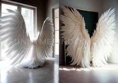 two large white wings sitting next to each other on top of a floor in front of a window