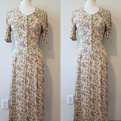 Beautiful vintage yellow/multi-colour flower-patterned short-sleeved maxi dress with button-up front. It looks like a mix of cotton and viscose, stretchy fabric. No visible stains or other defects. Size not written, but looks like EU/US S/M. Please read over the dress measurements carefully, to make sure the fit is okay for you, as I'm unable to accept returns/exchanges at the moment. Measurements are taken while garment is laid flat so please double the pit to pit and waist measurement. MEASUREMENTS (inches): Length 49" Pit to pit 17" Waist 14" For reference, mannequin measurements are: Size 6/8 Bust 36.5" Waist 25" Hip 37 Modest Fitted Maxi Dress For Garden Party, Yellow Fitted Rayon Dress, Fitted Yellow Rayon Dress, Flowy Short Sleeve Maxi Dress With Buttons, Fitted Short Sleeve Maxi Dress For Daywear, Flowy Maxi Dress With Buttons And Short Sleeves, Yellow Vintage Short Sleeve Dress For Spring, Yellow Short Sleeve Vintage Dress For Spring, Full Length Spring Daywear Dress