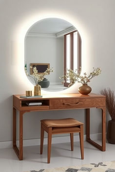 a mirror sitting on top of a wooden table next to a stool and vase with flowers