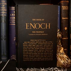 the book of enoch is on display in front of several bookshelves