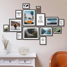 a bunch of pictures hanging on the wall above a table with a vase and chair