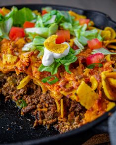 a close up of a plate of food with tortilla shells and toppings