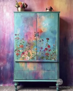 a painted cabinet with flowers on it