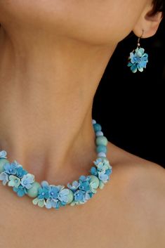 A cute necklace and earrings featuring sky blue and mint flowers.  This romantic bridal jewelry set is the perfect compliment to your wedding gown. Soft, feminine and very light weight.  Also a best seller for bridesmaids - try complementing with mesh dress.  #morecolors_Etsy #floral_jewellery #jewelry_set #blue_necklace #mint_necklace #wedding #bride_jewelry Pink Flower-shaped Necklace With Flower Decoration, Light Blue Flower-shaped Jewelry With Matching Earrings, Handmade Multicolor Flower-shaped Jewelry, Elegant Flower-shaped Necklace With Colorful Beads, Mint Green Flowers, Blue Floral Print Flower-shaped Jewelry, Mint Necklace, Mint Flowers, Floral Bridesmaid