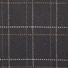 a close up view of a black and brown plaid fabric with white dots on it