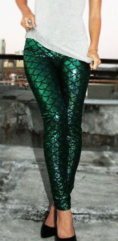 a woman wearing green mermaid leggings and black heels