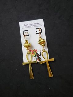 "Beautiful handmade  earrings made with a high quality gold plated metal Ankh symbol. Lightweight and easy to wear, these dangle earrings are 4\" long. Please come back and visit to check for more unique new designs and styles For more styles visit my Etsy shop:www.etsy.com/shop/SoftlySisterDesigns" Handmade Symbolic Ankh Earrings, Symbolic Gold Nickel-free Earrings, Handmade Adjustable Gold Chandelier Earrings, Handmade Ankh Earrings As Gift, Gold Spiritual Metal Earrings, Gold Spiritual Drop Earrings, Spiritual Gold Metal Earrings, Ankh Shaped Metal Earrings For Gift, Ankh-shaped Metal Earrings For Gift