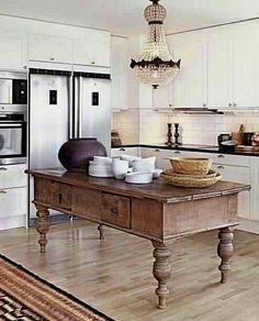 the kitchen is clean and ready to be used for cooking or baking, while also being used as a dining room table