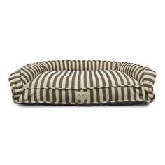 a black and white striped dog bed with a tag on the front, sitting against a white background