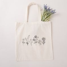 "Flower Tote Bag Cute Tote Bag Floral Tote Aesthetic Bag Market Bag Tote Bag Pattern Canvas Tote Bag Shoulder Bag Shopping Bag Cute Tote Bags One canvas tote bag with original hand drawn wildflower artwork, perfect for bridesmaid gifts, reusable shopping bags, measuring at 15.75\"h x 15.25\"w and with a handle length of 21.5\" 100% cotton sheeting Reinforced handle stitching One size Designed with Love" Eco-friendly Tote Bag For Personal Use, Eco-friendly Pouch Bags For Daily Use, Eco-friendly Bags With Removable Pouch For Gifts, Eco-friendly Bag With Removable Pouch For Gift, Eco-friendly Bag With Removable Pouch As Gift, Large Capacity Tote Bag For Personal Use, Wildflower Artwork, Bridal Party Getting Ready, Flower Tote Bag