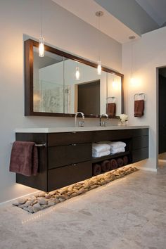 a large bathroom with two sinks and mirrors