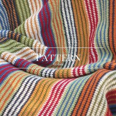 a multicolored blanket with the word pattern on it