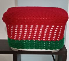 a red and green basket sitting on top of a table