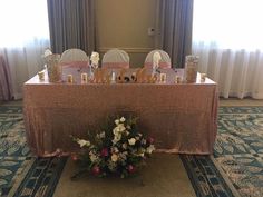 the table is set up with white and pink flowers