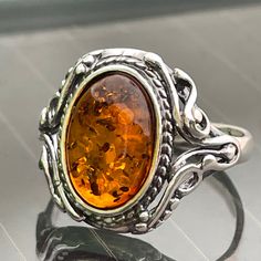 "* Materials: Baltic Amber,925 Sterling Silver * Stone color: Honey * Stone size:0.5\"X 0.4\"(12.5 mmx10mm) * Weight: 3 gram * Christmas wrapping available, see pictures. Please specify ribbon color you prefer in the box that says message for shop owner. * This ring is for adults only. Natural Baltic Vintage Amber Ring . Did you know that Amber was one of the first materials ever used for accessorizing? Ornaments made out of amber were found on prehistoric people dating all the way back to the S Prehistoric People, Stroudsburg Pa, Amber Fossils, Amber Crystal, Natural Jewelry, Crystal Healing Stones, Amber Ring, Jewelry Sterling Silver, Amber Jewelry