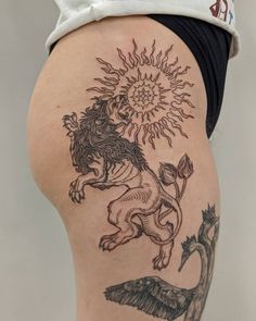 a woman's thigh with tattoos on it and a sun above the horse that is flying in the sky