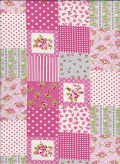 a patchwork quilt with pink and green flowers