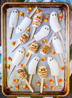 halloween marshmallow pops on a baking sheet