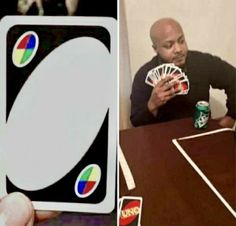 a man sitting at a table with cards and a can of pepsi in front of him