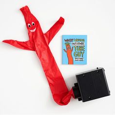 a red umbrella with a book on it and a black object in the middle next to it