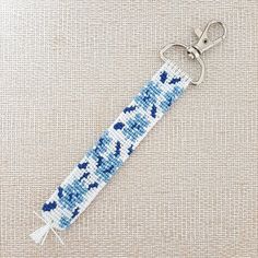 a blue and white beaded key chain