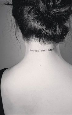 the back of a woman's neck with words written on her left side and an inscription that reads courage, dear heart