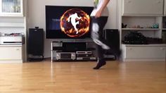 a man is dancing in front of a television