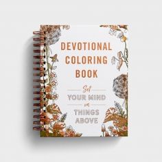 a book with an orange and white floral design on the cover that says,'devotion coloring book '