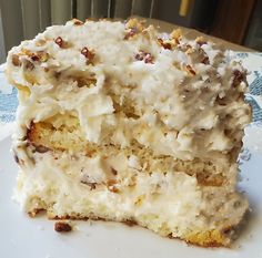 a close up of a piece of cake with frosting and nuts on it's side