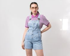 "Vintage 90's denim overall shorts in light blue - brand: Redstar - 5 pockets - adjustable suspenders - buttoned up from the waist up - materials: 100% cotton denim SIZE size from label: W29 best fits women: S/M MEASUREMENTS bust: open waist: 30 inches (76 cm) hips: 38,5 inches (98 cm) inseam: 5,5 inches (14 cm) The model is 5'9\" (174 cm), measures 35-27-38 (90-69-96 cm) CONDITION: The shortalls in great vintage condition. Washed, ready to wear." Medium Wash Short Overalls For Summer, Summer Medium Wash Short Length Overalls, High Waist Cotton Shortalls For Summer, High-waist Cotton Shortalls For Summer, Summer High Waist Cotton Shortalls, Fitted Shortalls With Suspenders For Spring, Vintage Medium Wash Shortalls For Spring, Retro Cotton Shortalls For Spring, High Waist Medium Wash Shortalls For Summer