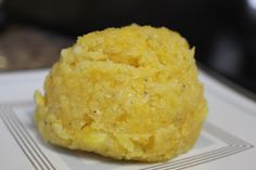 a close up of a food item on a plate with a black object in the background