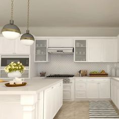 a kitchen with white cabinets and counter tops