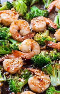 shrimp and broccoli stir fry with sesame seeds in a skillet, ready to be eaten