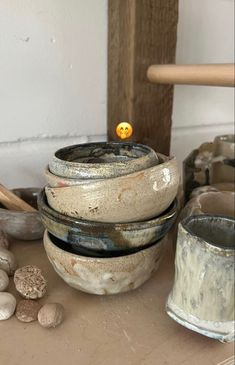 several bowls are stacked on top of each other and one has an orange ball in the middle