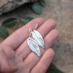 These fine silver earrings are handcrafted using real leaves from my garden. Their natural curved shape catches the light as they move, and every vein and tiny detail of the leaf can be seen. The leaves used for these earrings burn away in the firing process and leave their impression forever in silver. No two are ever alike, just as no two leaves are ever the same. The lever back earring wires are sterling silver. The leaves are lightly oxidized to bring out the texture of the veins. The leaf i Real Leaves, Botanical Jewelry, Metal Clay, Everyday Earrings, Silver Pieces, Artisan Craft, Leaf Earrings, Silver Leaf, Pure Silver