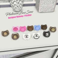 a bunch of buttons that are on top of a table with the words designer bunny / pacifier